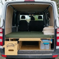 Overview of the full-size unfolded bed platform inside the van