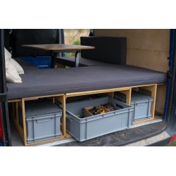 VanBus BASIC camping box with a grey mattress and unfolded dining table