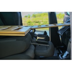 Side view through the sliding doors of the bed unfolded over the folded second-row seats
