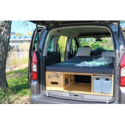 Comfortable sleeping space with a blanket and pillows with the kitchen module drawers closed