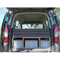 Folded Vacamod camping box in the car trunk with grey mattresses stacked and Euro crate storage space at the bottom